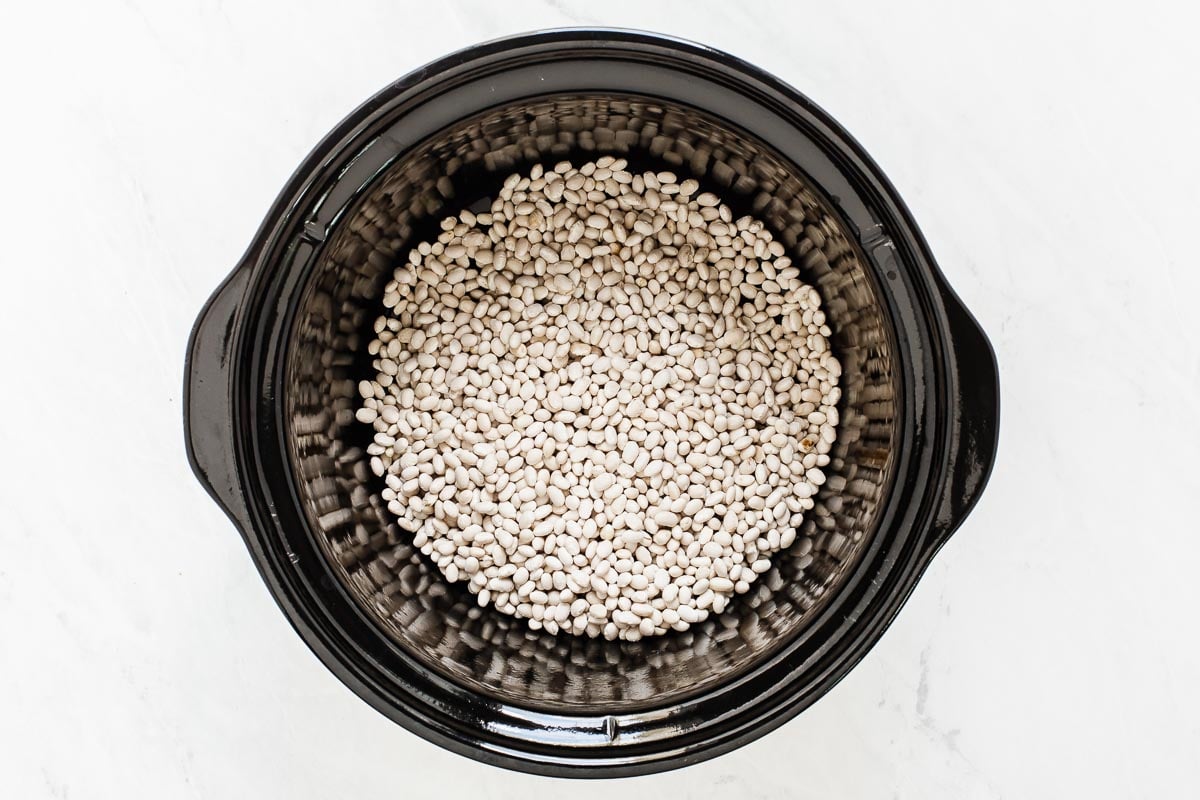 White beans in black slow cooker.