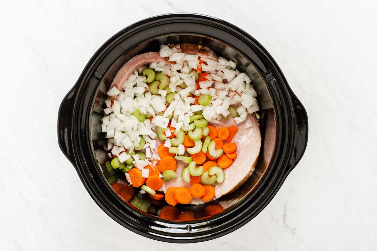 Onions, carrots and celery in slow cooker.