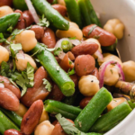Close up of three bean salad with green beans, kidney beans, and chickpeas.