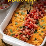 Casserole dish with melted cheese and pico de gallo.
