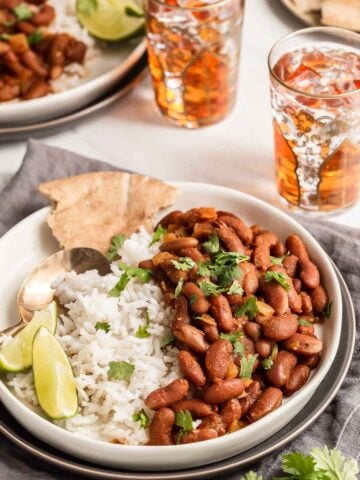 Kidney beans on plate with rice and naan.