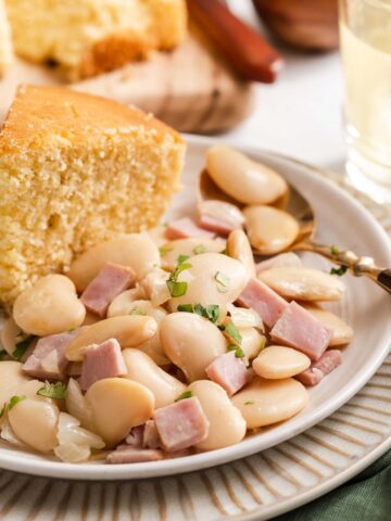 Butter beans on plate with cornbread.