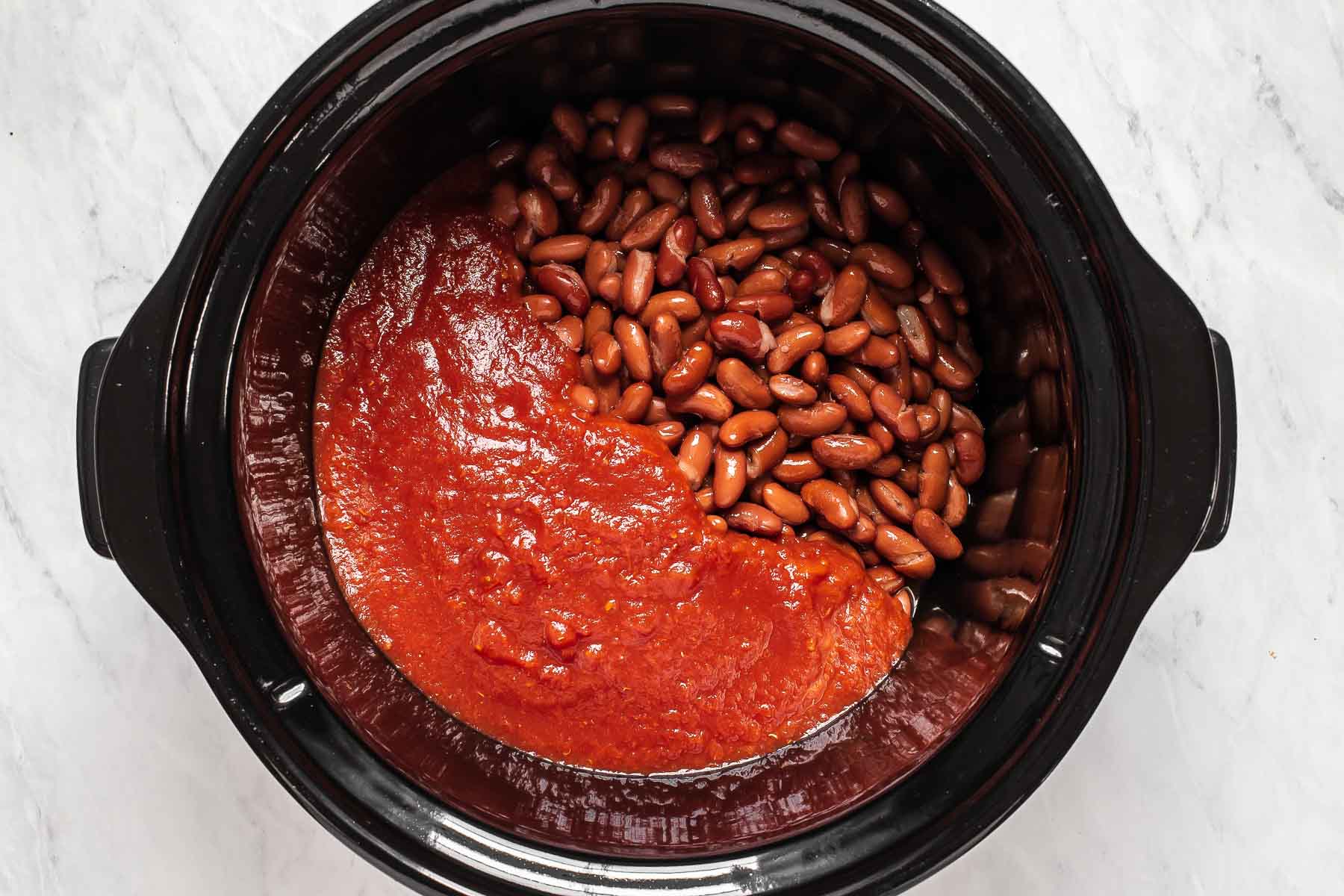 Tomatoes and kidney beans in slow cooker.