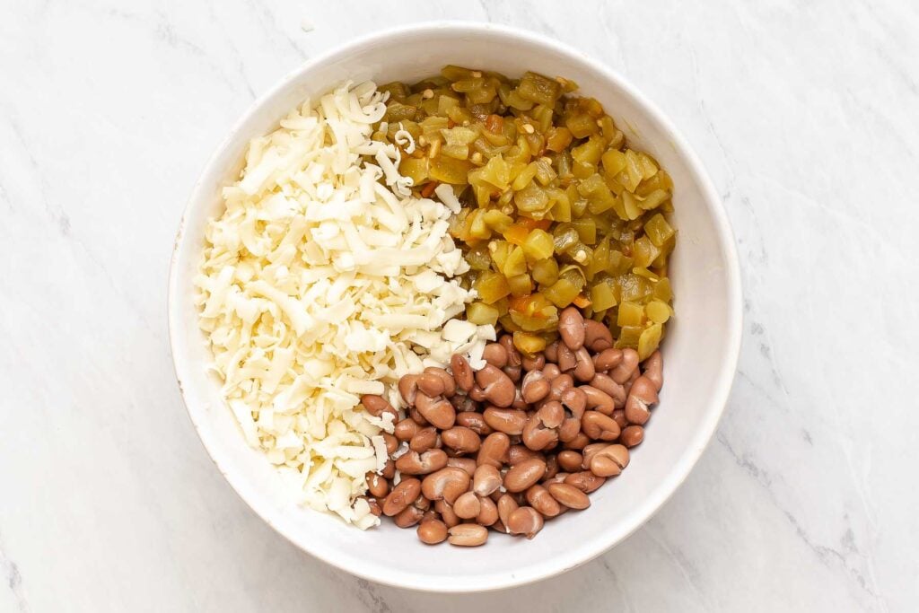 Bowl of beans, cheese and green chiles.