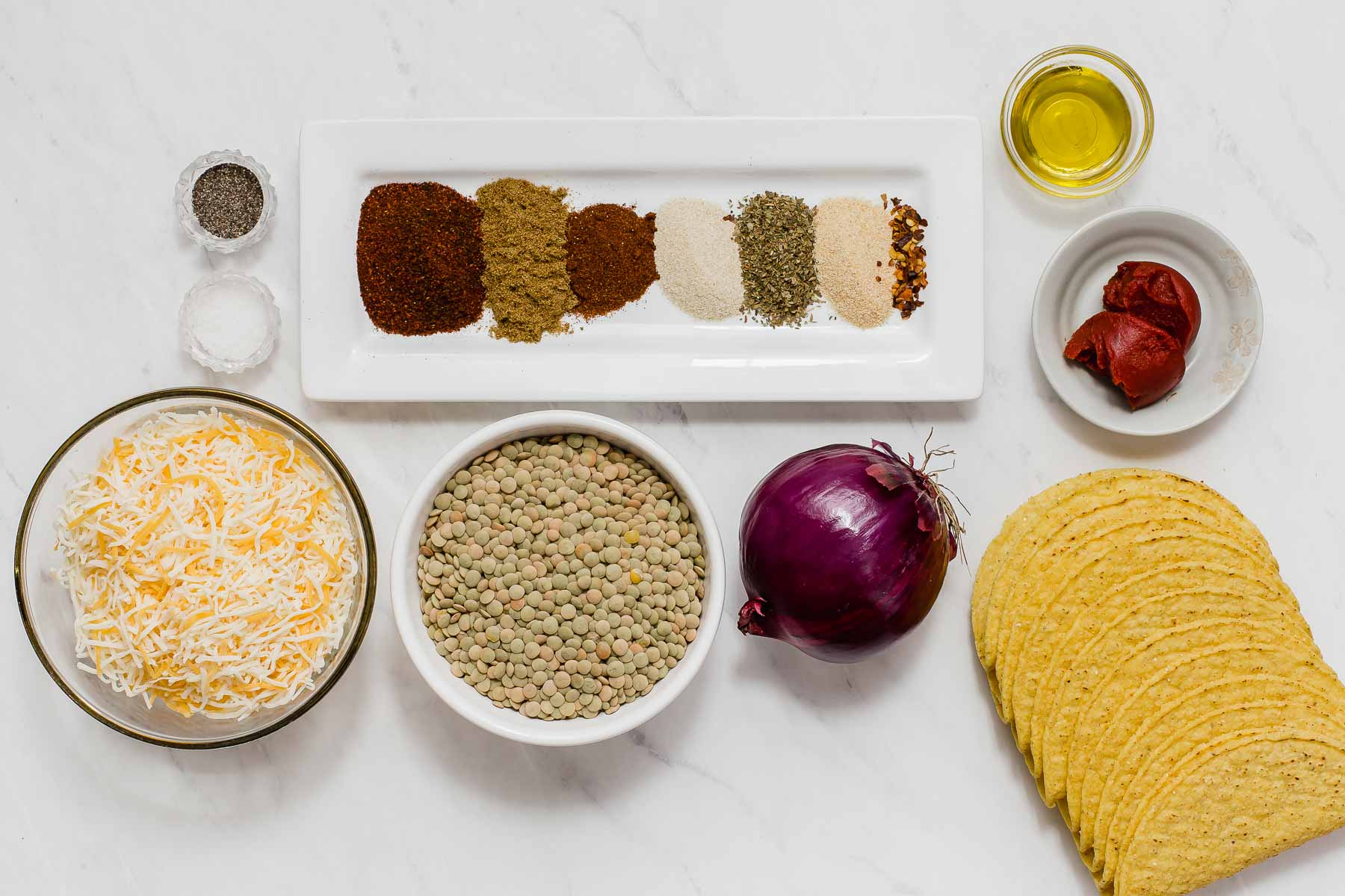 Ingredients for making lentil tacos on white table.