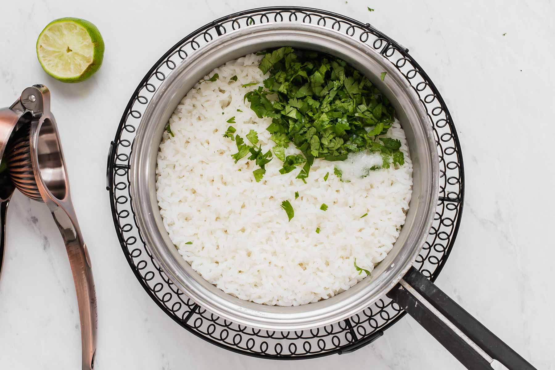 White rice with fresh cilantro and lime juice on top.