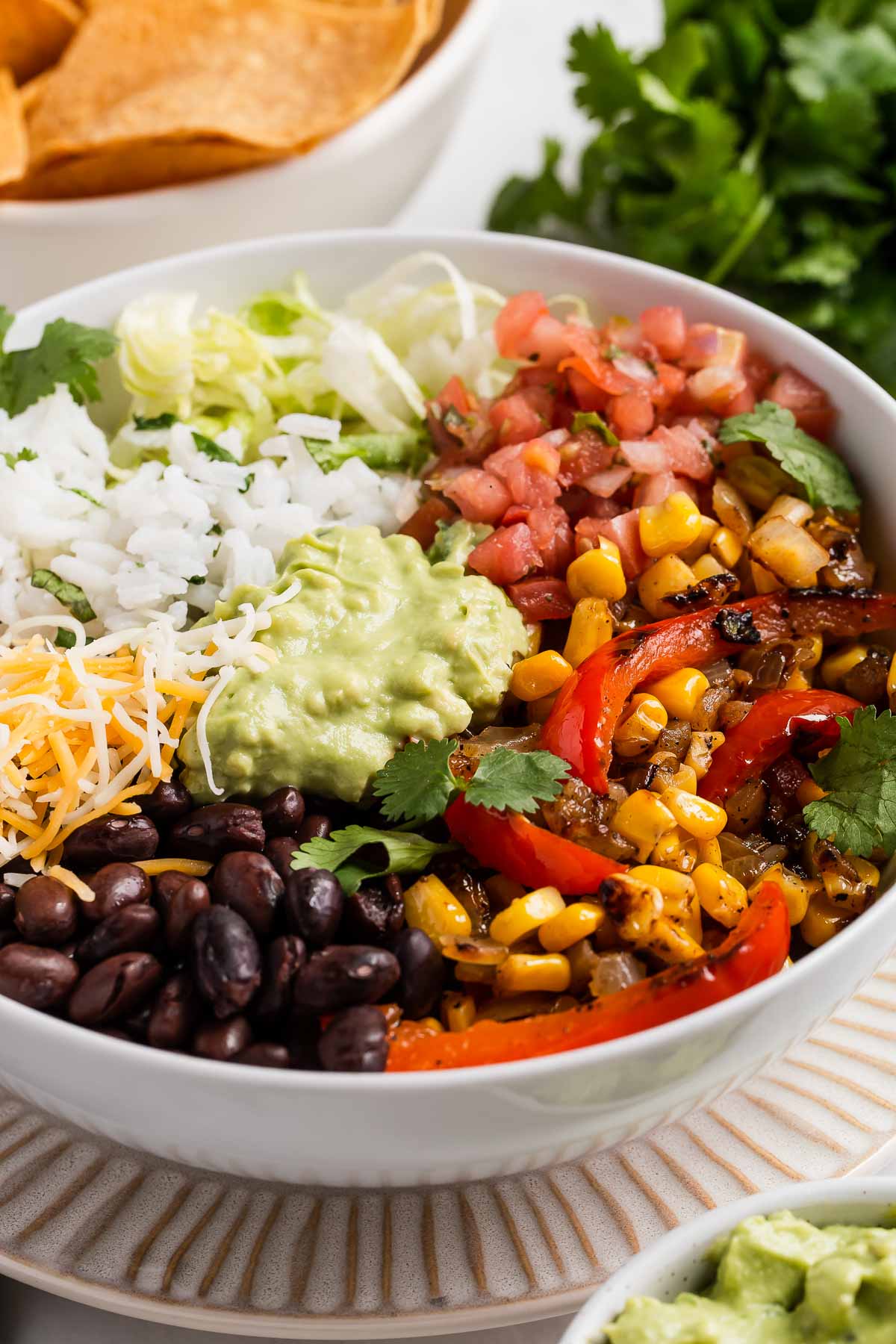 Vegan burrito bowl with black beans, veggies and guacamole.