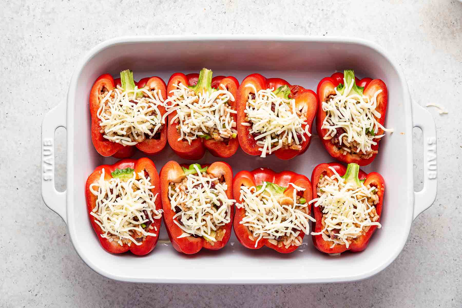 Pan of vegetarian stuffed peppers topped with cheese.