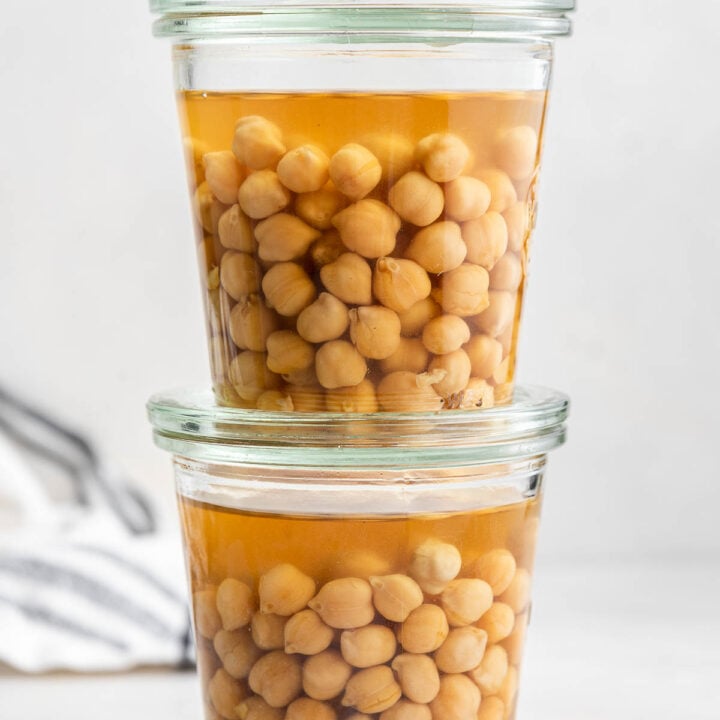 Two glass mason jars full of instant pot chickpeas.