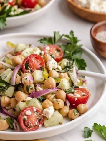 Mediterranean Chickpea Salad on white plate with parsley.