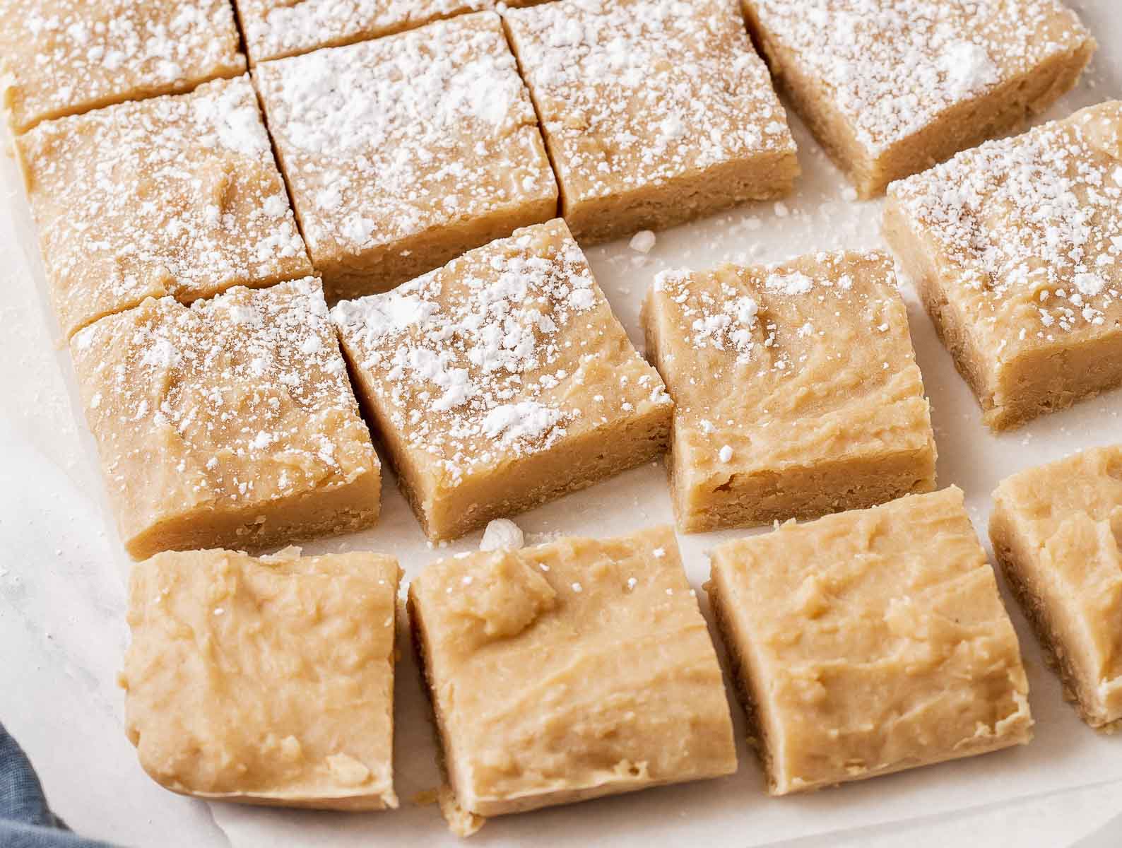 Cut squares of blonde dessert bars dusted with powdered sugar.