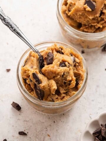 Two glass bowls with chickpea cookie dough and spoons.