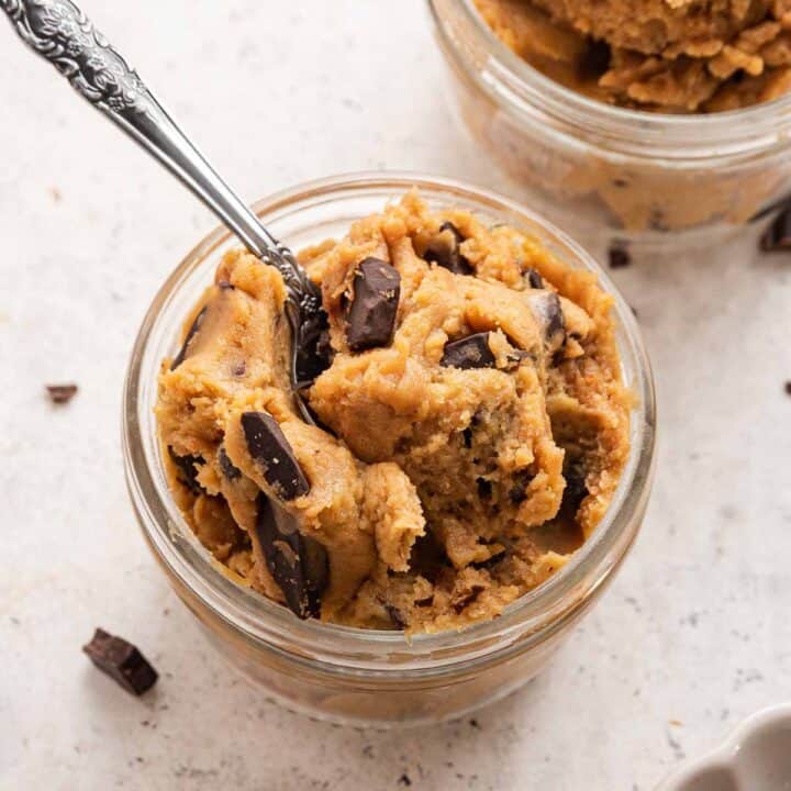 Two glass bowls with chickpea cookie dough and spoons.