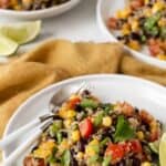 Pin image for black bean quinoa salad on white plate with text.