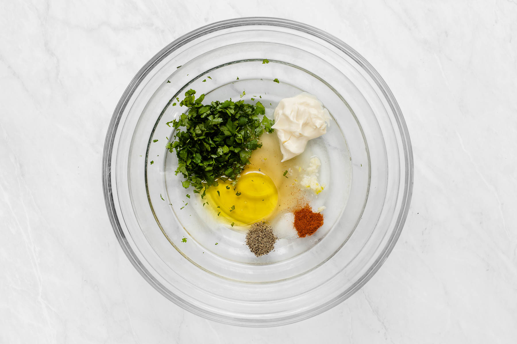 Clear bowl with cilantro, oil, mayo and spices to make dressing.