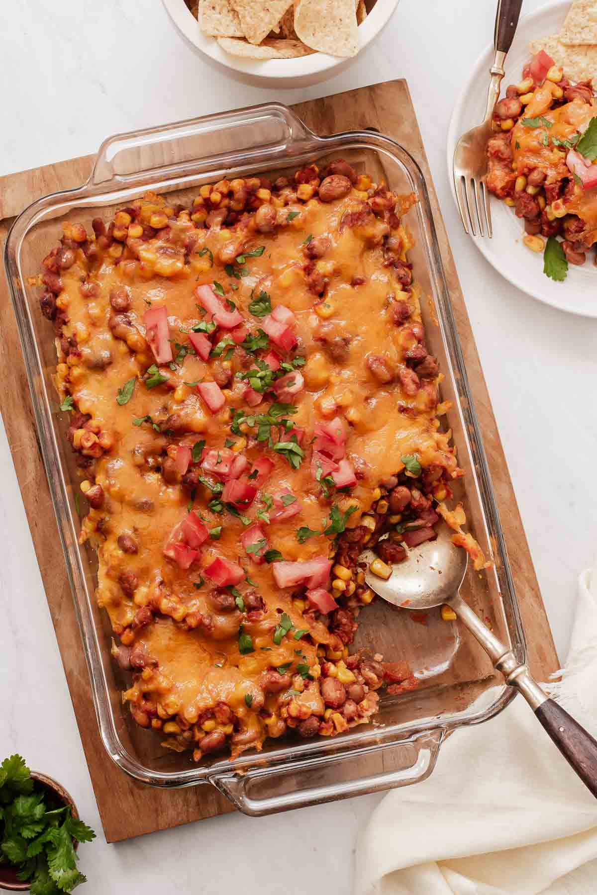 Pinto beans casserole covered in cheese in a glass 9x13 dish.